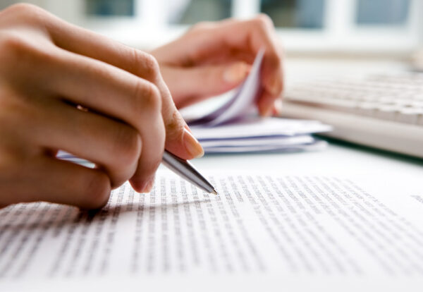 Close-up of secretary’s hands doing paperwork